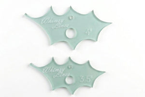 A close up of two holly leaf acrylic templates 