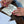 A close up of a hand using a clear Whimsy Lines acrylic template to draw organic flowing patterns in a sketchbook