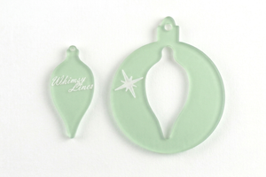 a close up of two acrylic bauble templates 