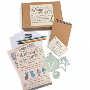 Whimsy Lines Spring Mindful Drawing Kit for adults featuring acrylic templates, sketchbook, fine liner pen, and pencil in a gift box.