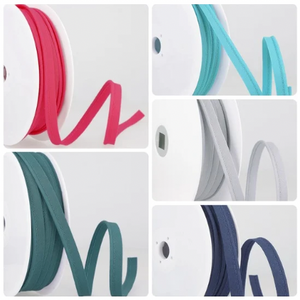 A bundle of skinny 2mm polycotton flanged piping trim showing the narrow cord and insertion flange.